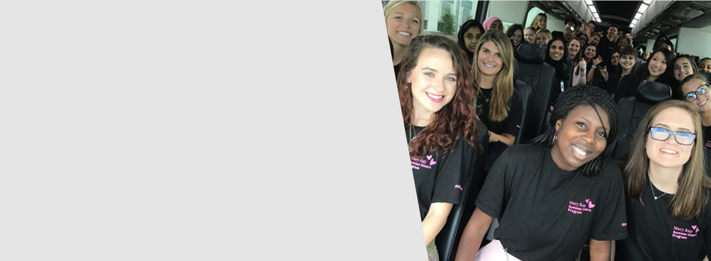 Large group of Mary Kay interns in branded shirts.