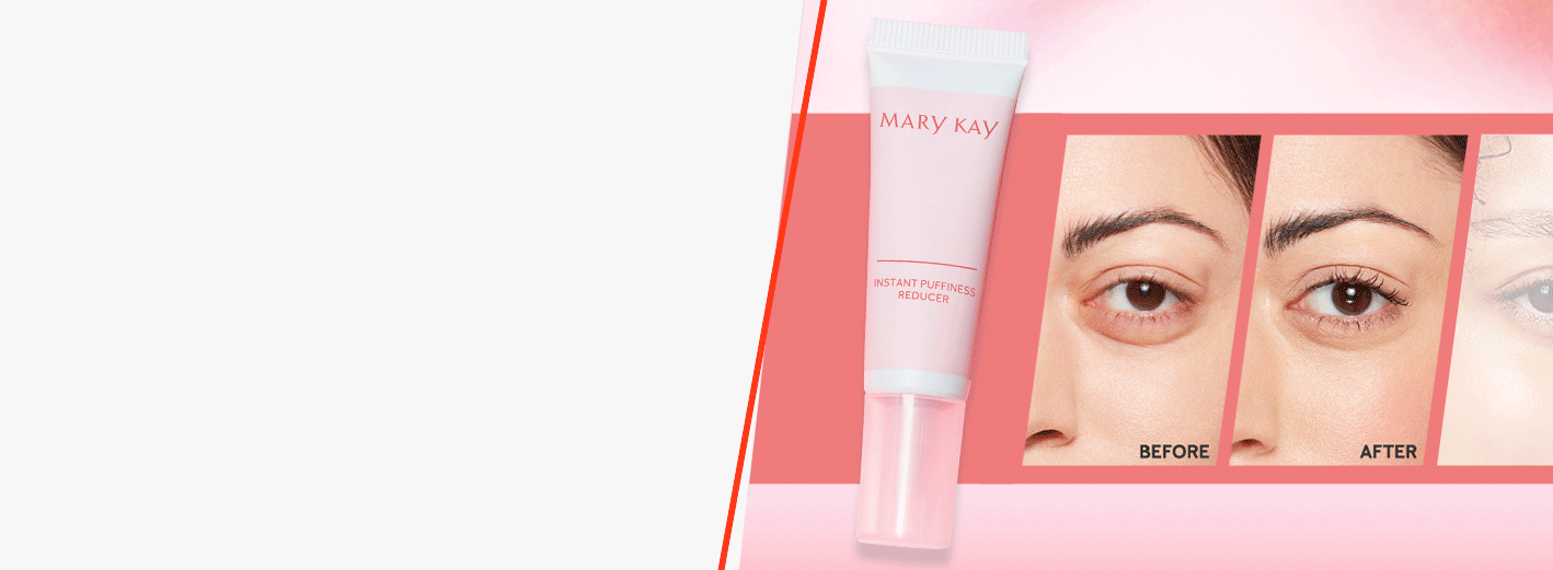 Model looking in the mirror with her finger touching her eye while she holds a tube of Mary Kay® Instant Puffiness Reducer