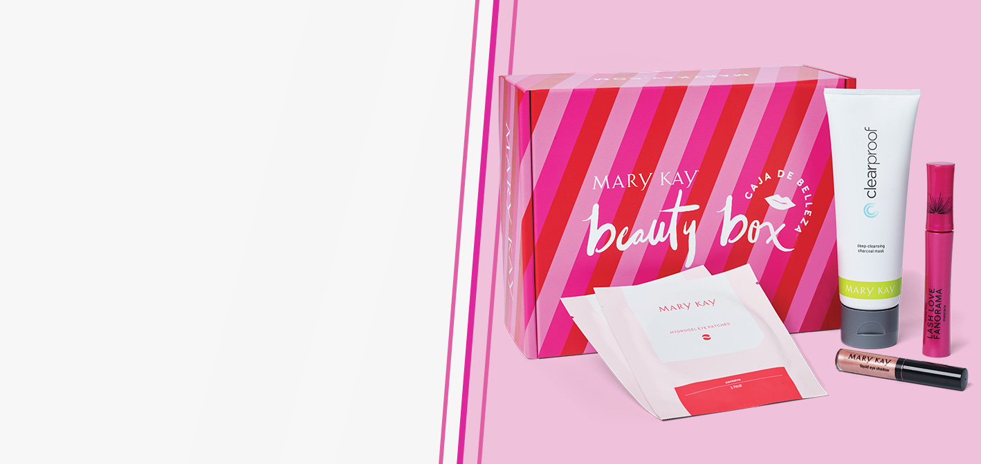 Limited-Edition Mary Kay® Beauty Box set against a pink background with the lid closed and assorted products styled outside