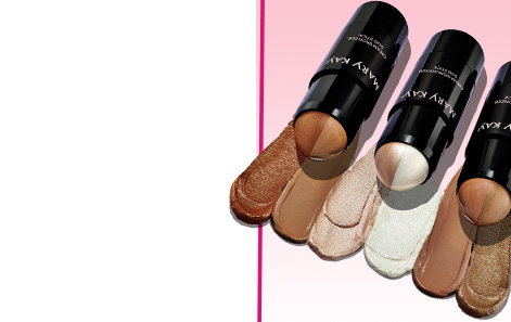 Flat lay of limited-edition Mary Kay® Cream Highlighter Duo Stick and Cream Bronzer Duo Sticks styled in a row, each atop its own textured product rub