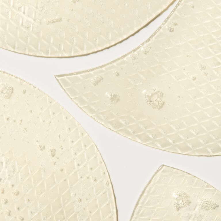 Light yellow snail gel face patches resting on a white background