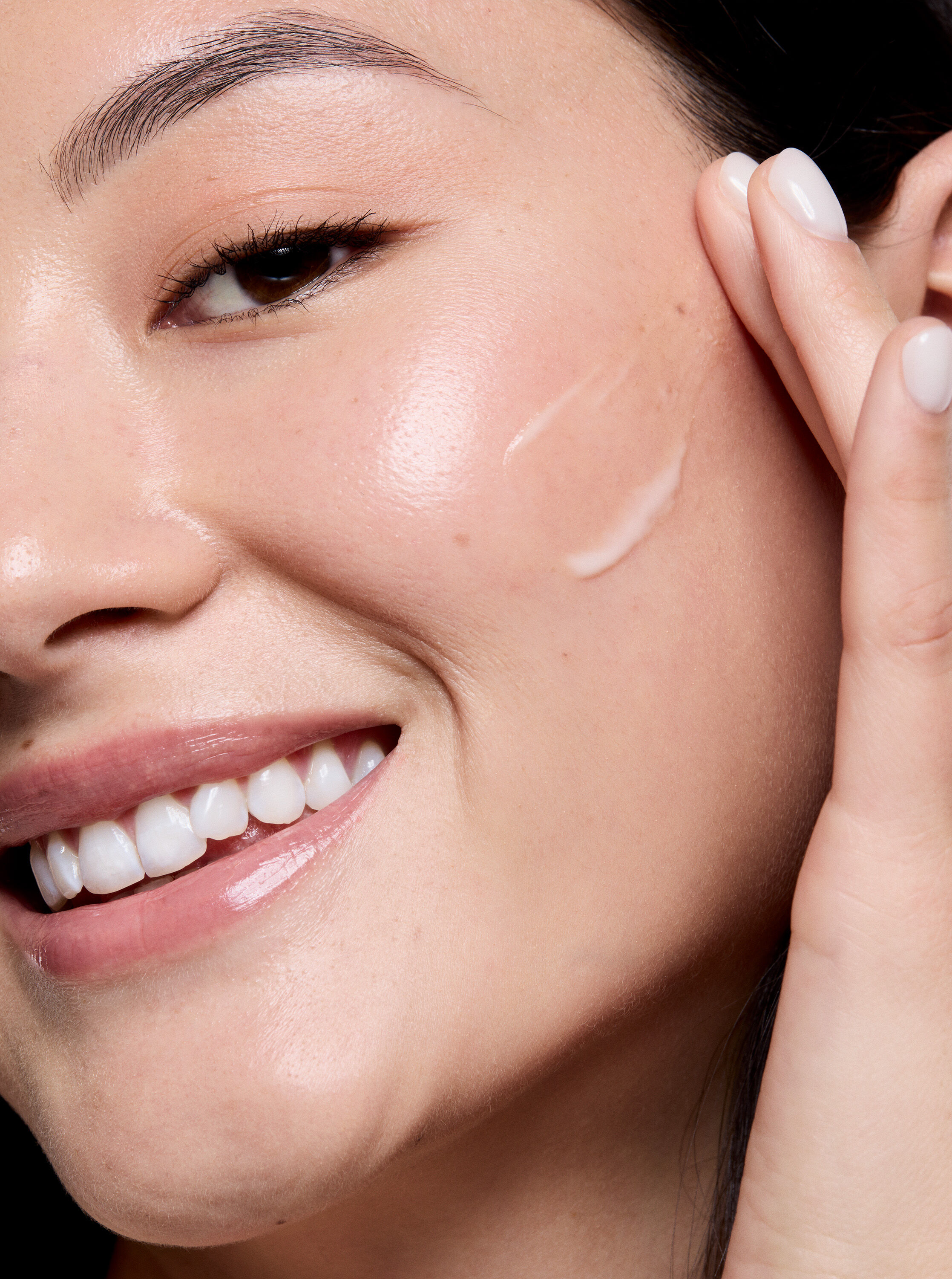 Woman applying Mary Kay Retinol 0.3 cream to her cheek
