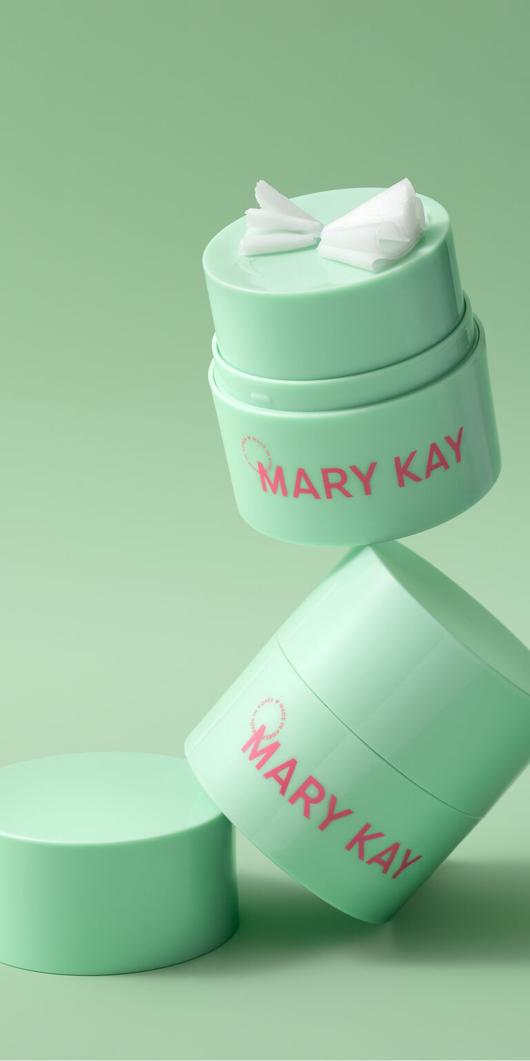 Floating stack of green jars of Mary Kay Melt-In Cleansing balm