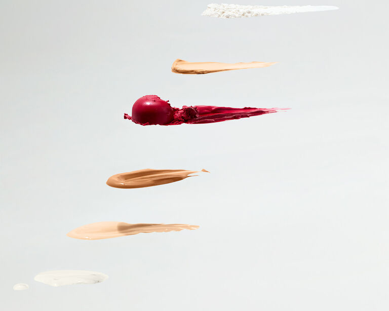 Overhead shot of product swipes and swatches against a gray background 