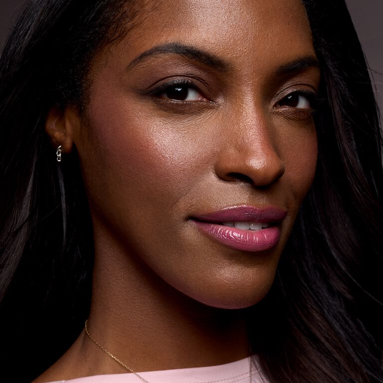 Smiling model with glossy pink lips and lifted cheeks