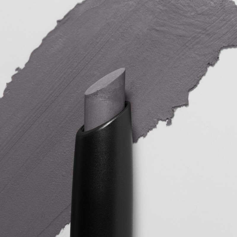 Mary Kay Matte Eye Shadow Stick in Moonshadow slanted tip in foreground swatch in background
