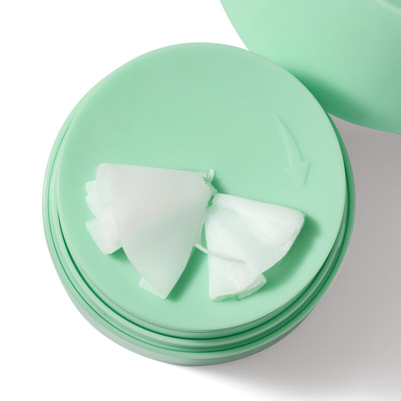 White Mary Kay Melt In Cleansing Balm sitting on top of green jar