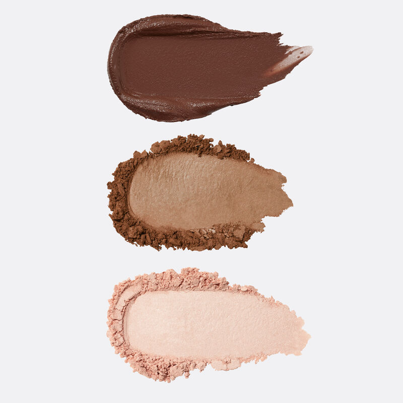 Product rubs of the Brow Pomade, Brow Powder and Highlighter included in the limited-edition Mary Kay Brow Kit in Brunette against plain background