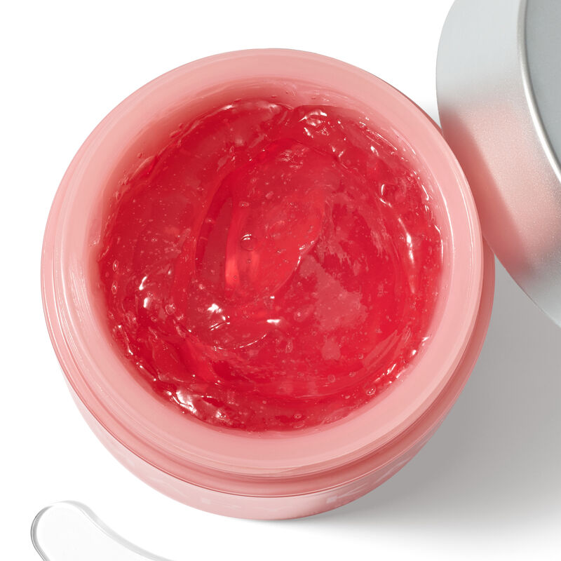 Primer plano de gel hidratante con col&aacute;geno rosa en un frasco rosa claro