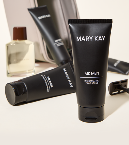 Mary Kay MKMen Invigorating Face Scrub tube displayed with other men's grooming products in the background.