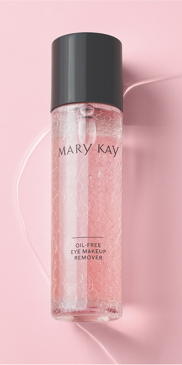 Botella del Mary Kay Oil Free Eye Makeup Remover agitado sobre un fondo rosa
